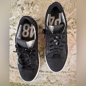 P448 sneakers featuring a black & metallic leather upper with black cotton laces